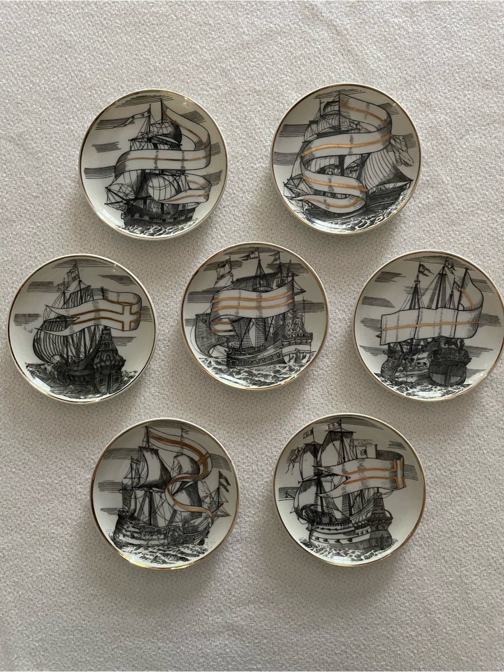 Vintage Mid Century porcelain coasters. Black sailing ships with gold accents.